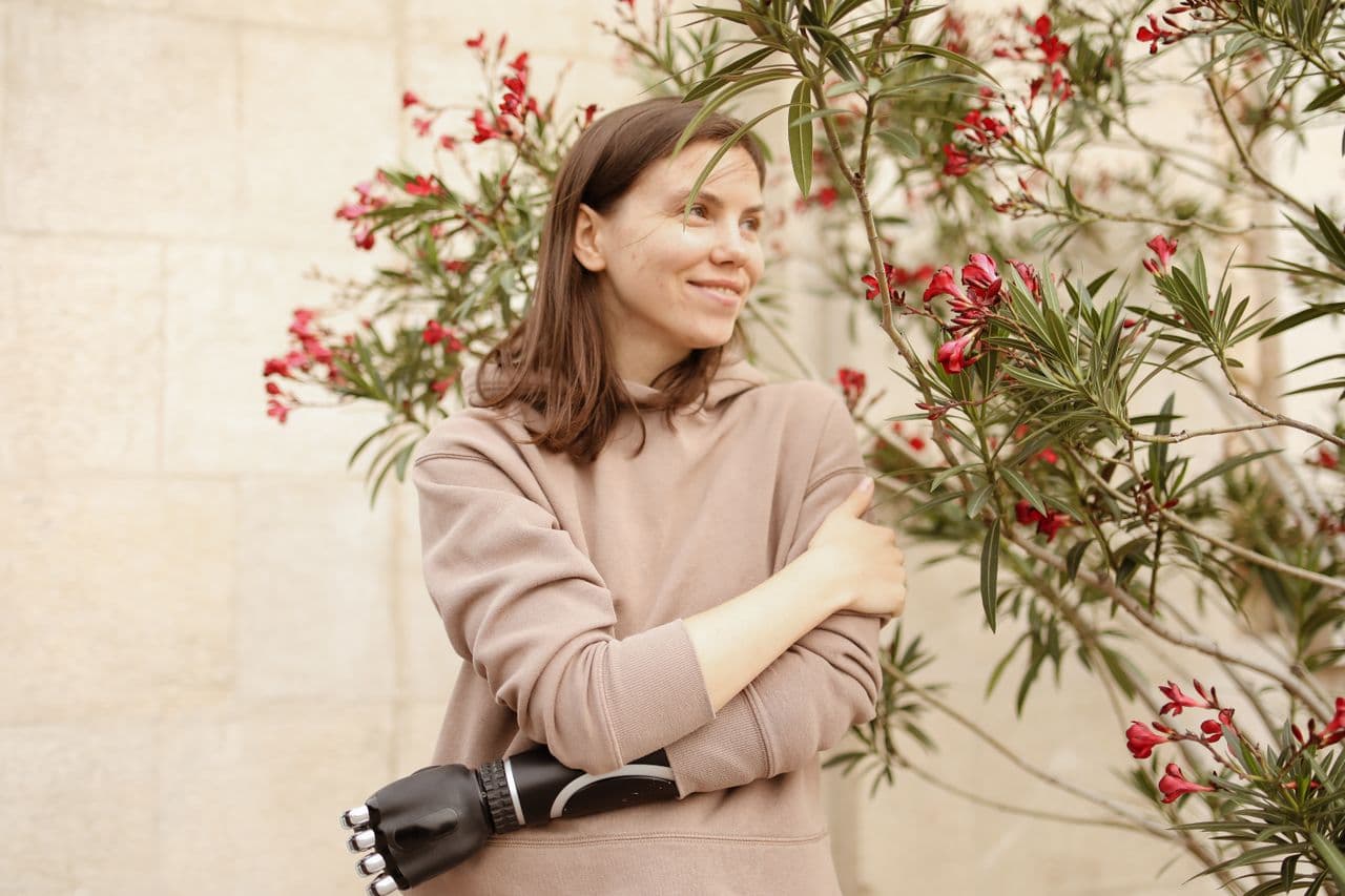 A woman enjoying a quiet moment beside flowering greenery
