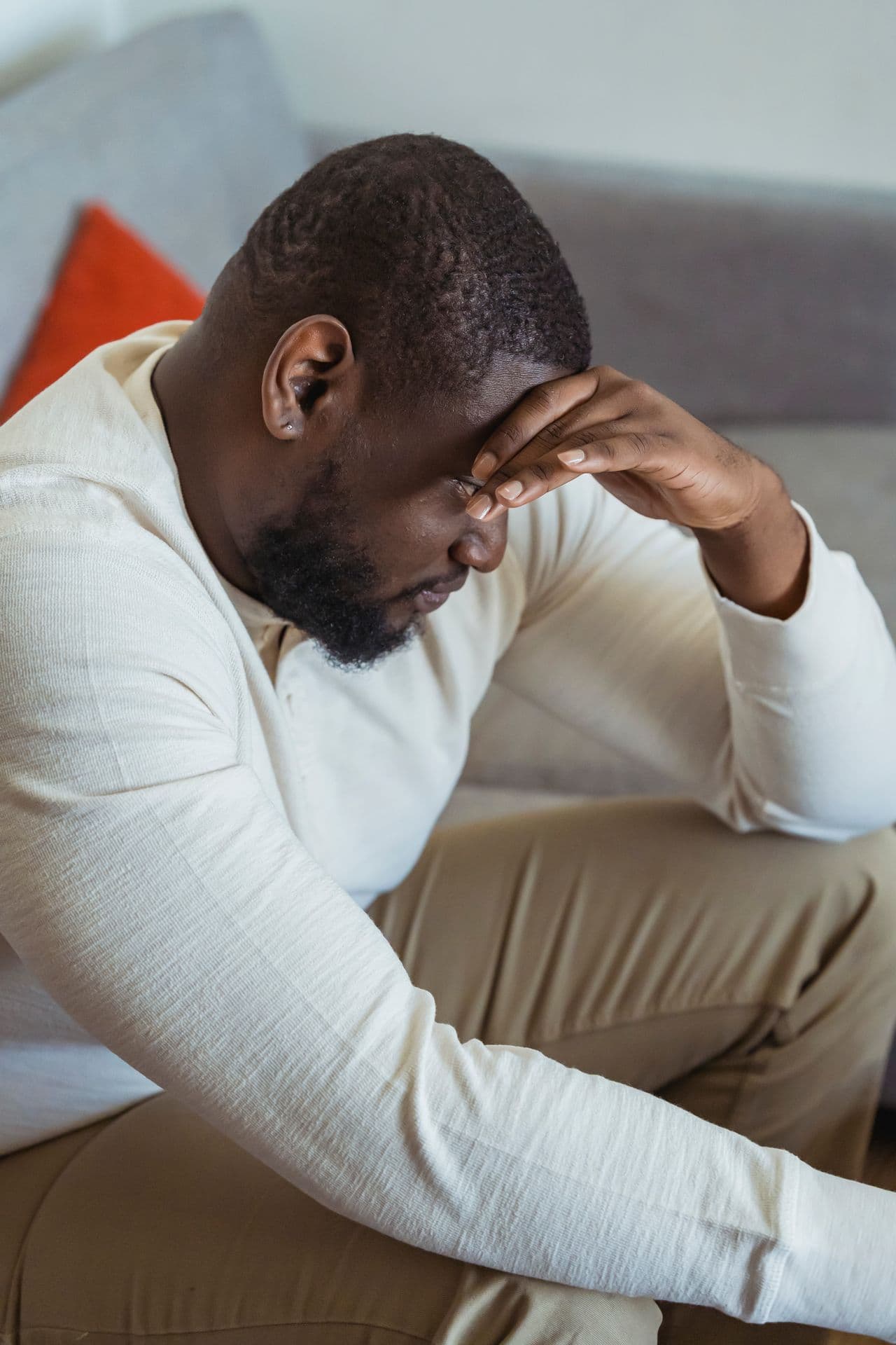 A man taking a quiet, reflective moment at home